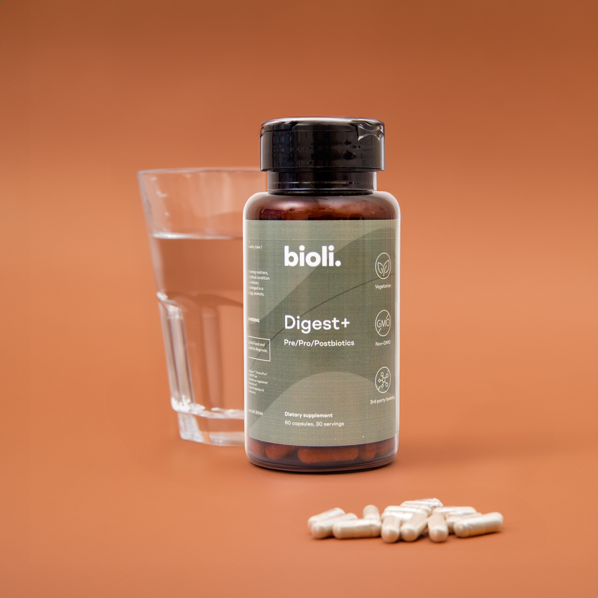 Bioli probiotics bottle with glass of water